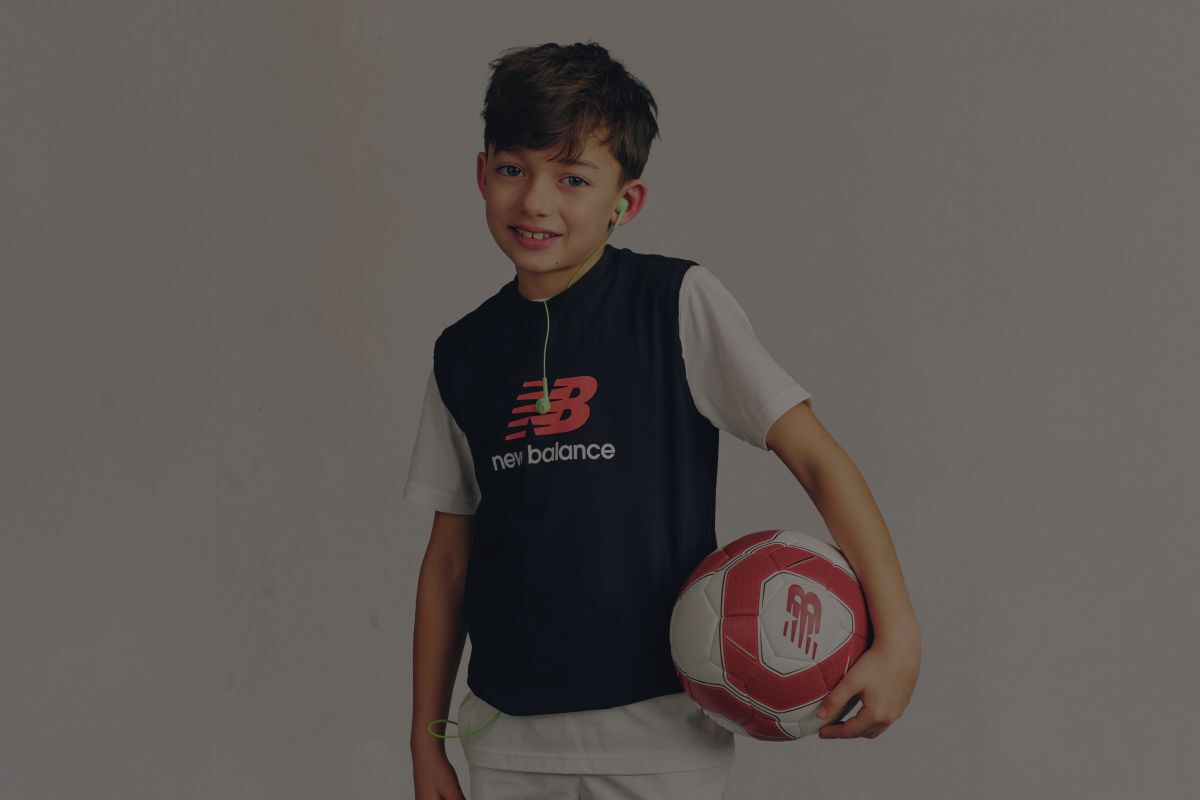 A child wearing a New Balance graphic tee.