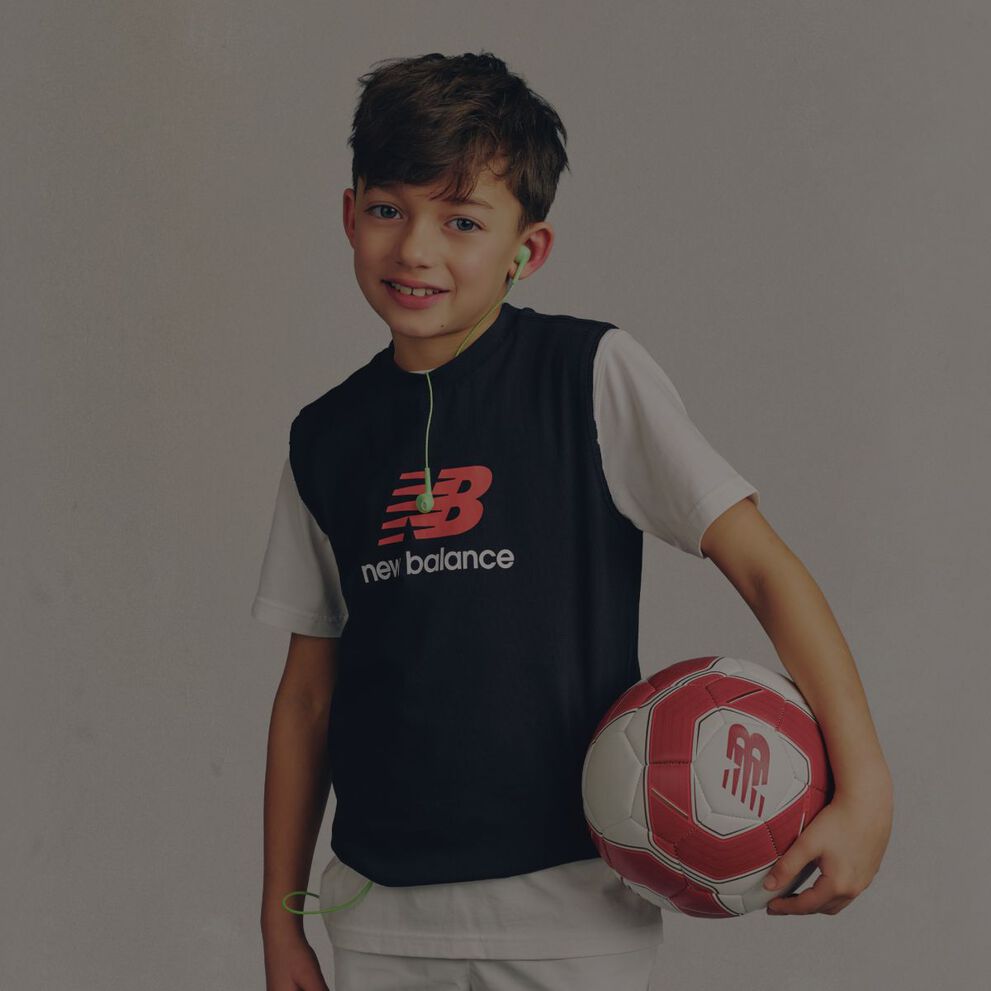 A child wearing a New Balance graphic tee.