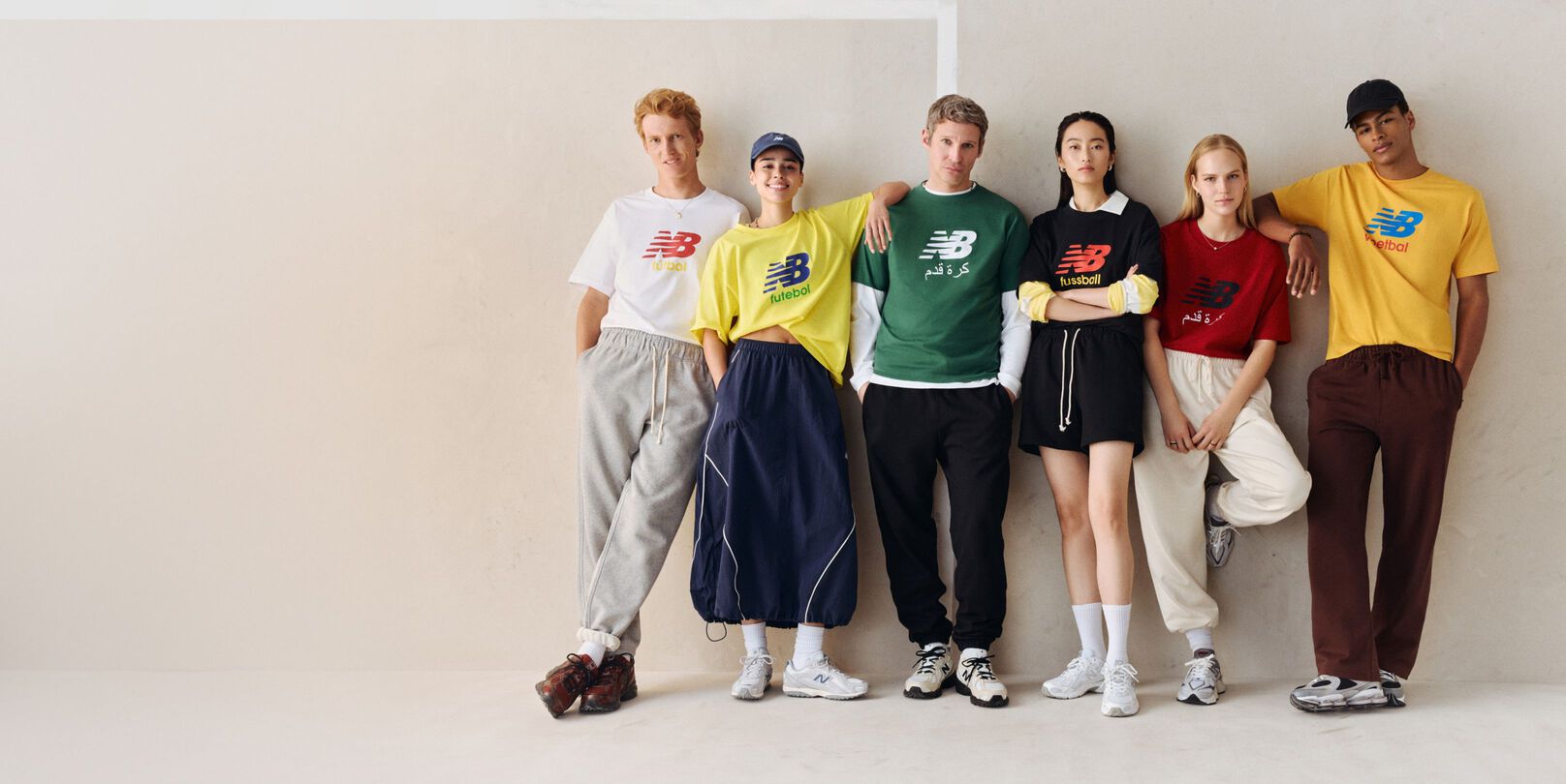 A group of people wearing different color soccer graphic t-shirts.