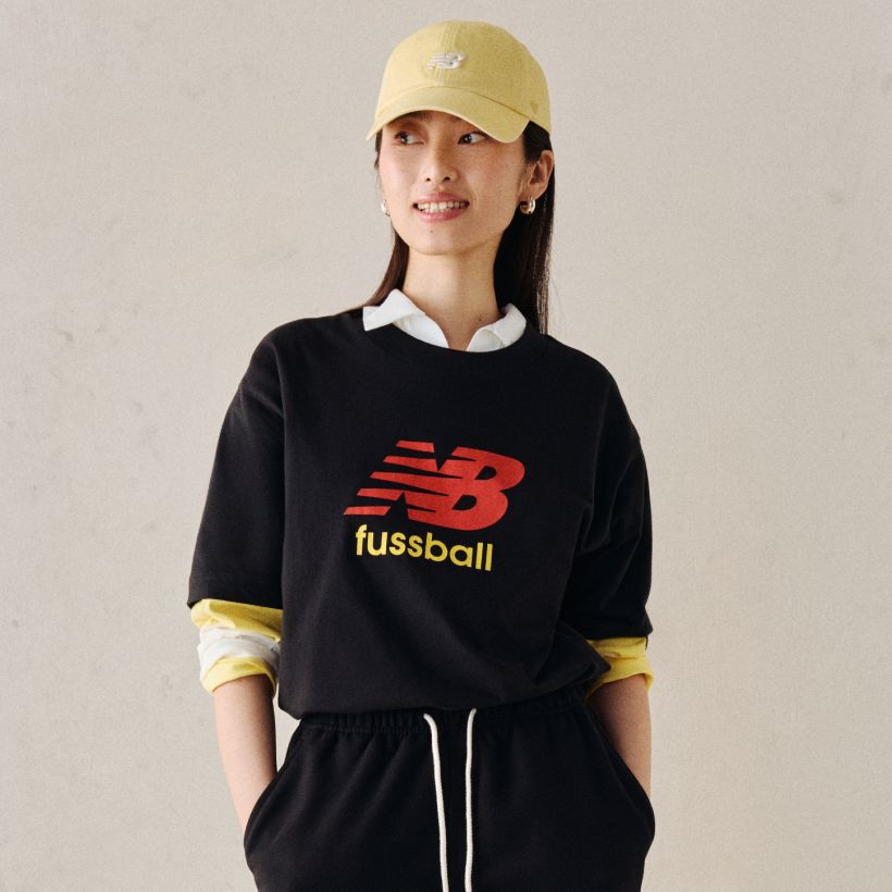 A person wearing a soccer graphic tee.