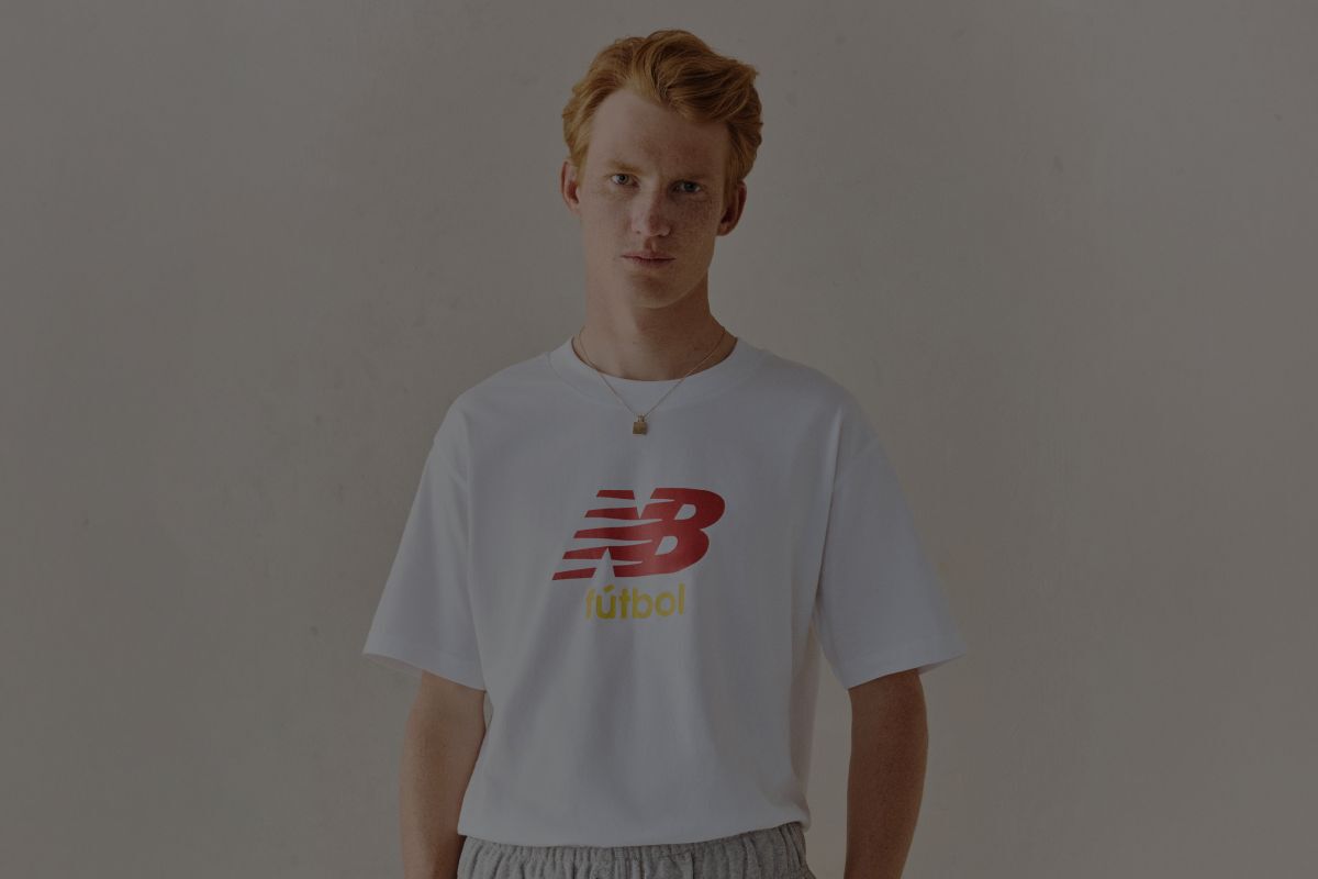 A man wearing a New Balance graphic tee.